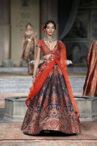 Model showcasing traditional attire on a fashion runway.