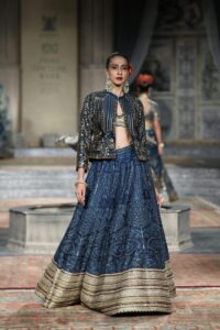 Model showcasing a traditional Indian lehenga at a fashion show in New Delhi.